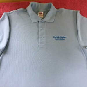 Light Blue Polo Shirt with embroidery that says Norfolk Healers Association