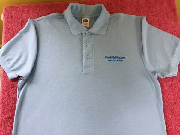 Light Blue Polo Shirt with embroidery that says Norfolk Healers Association